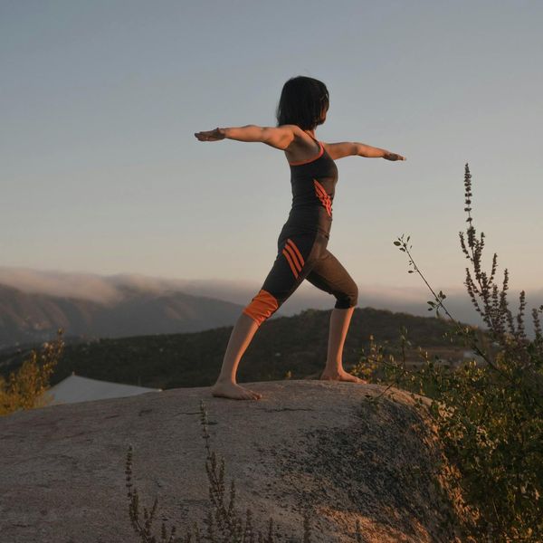 A person in a balanced warrior yoga pose, showing strength and focus.